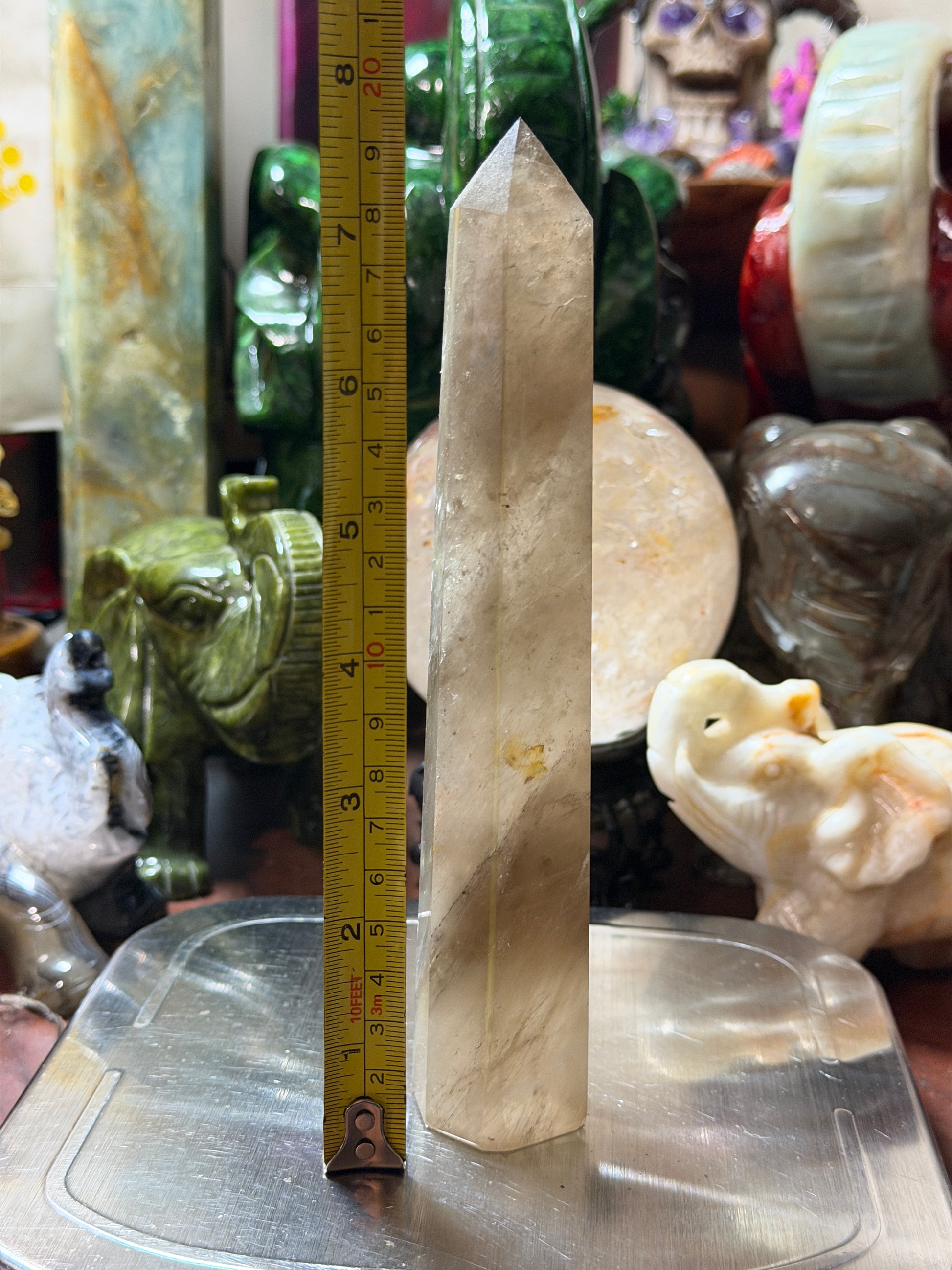 Smoky quartz crystal tower showing approximate height measurement
