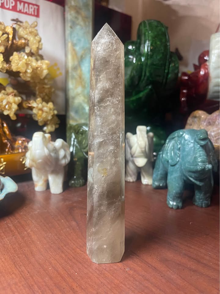 Side view of natural smoky quartz tower showing smoky brown tones
