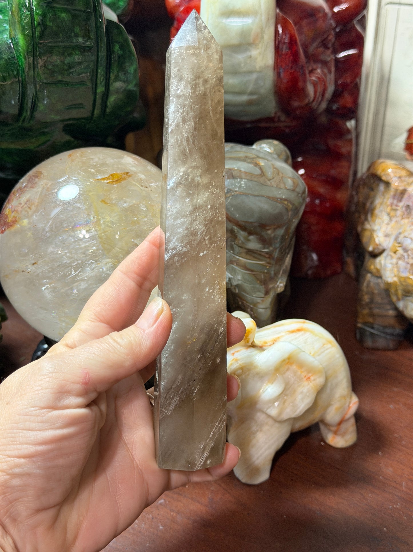 Smoky quartz crystal tower standing upright, front view