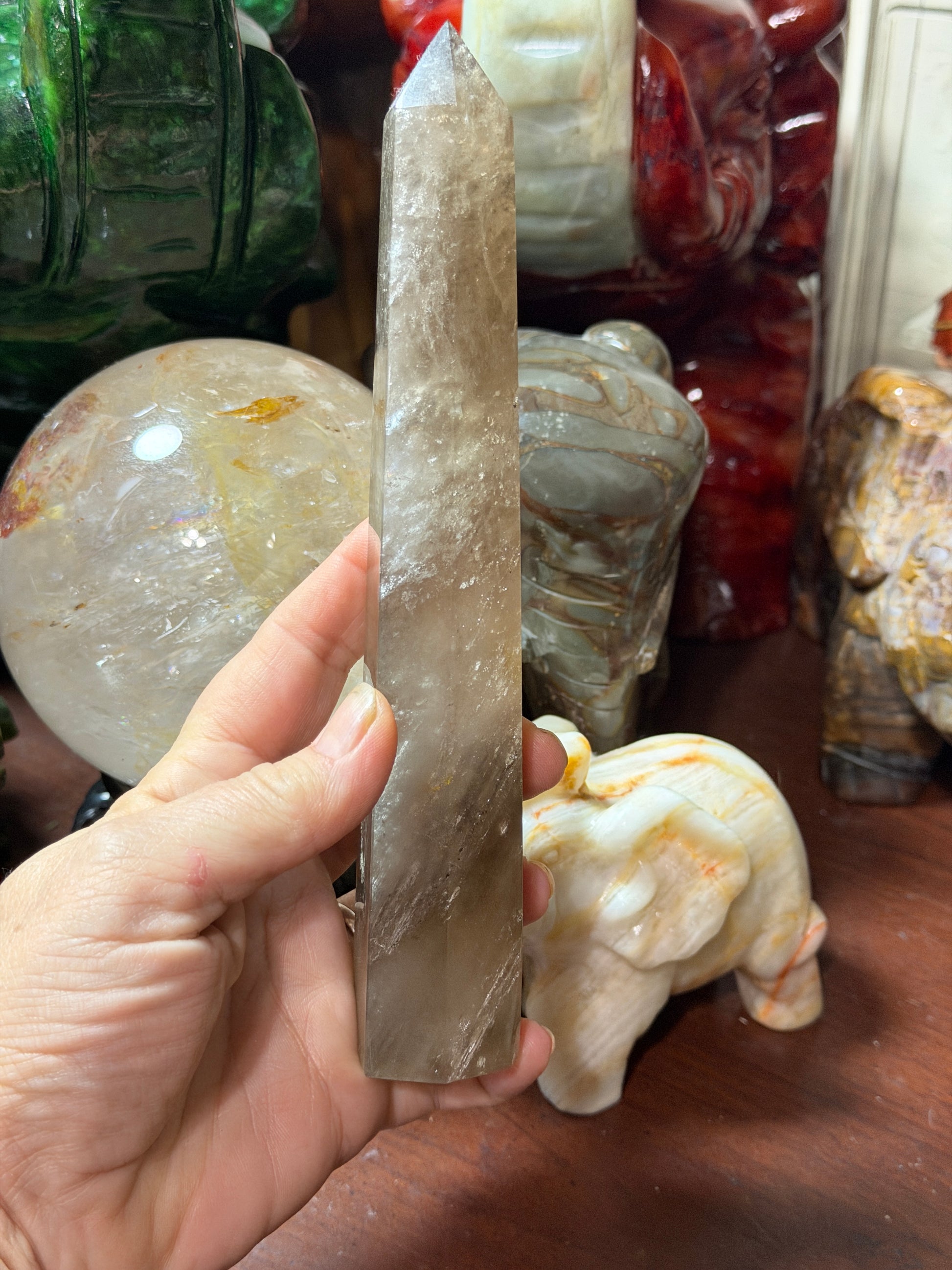 Smoky quartz crystal tower standing upright, front view